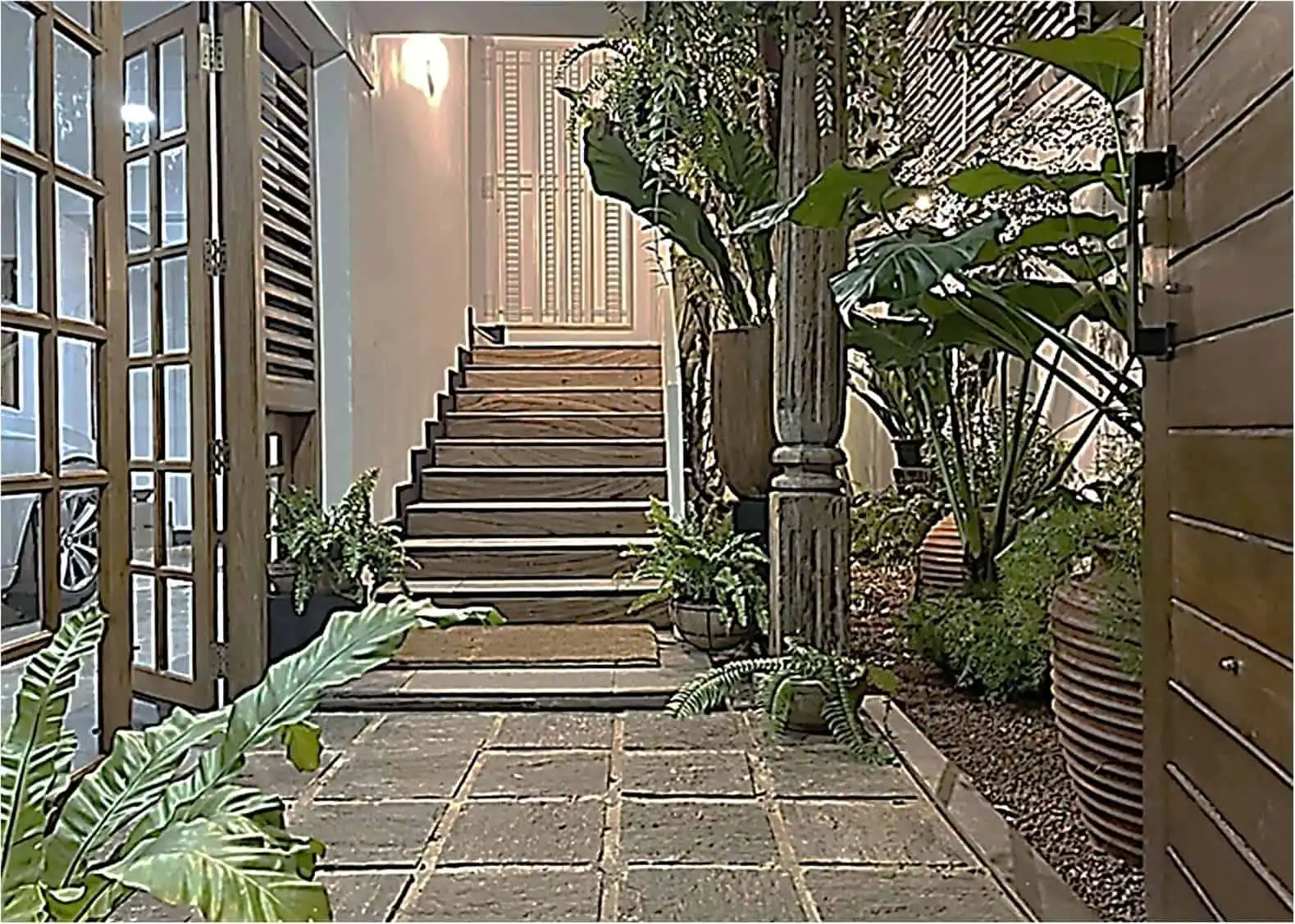 Elegant entrance staircase at Loxwood House, Colombo, showcasing lush greenery and modern design.