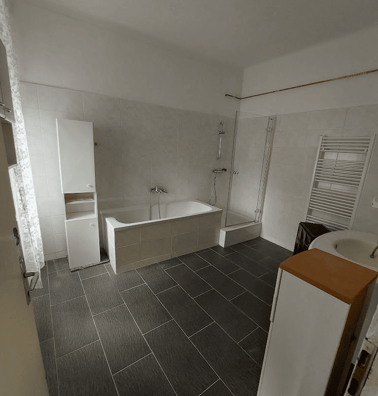 Apartment bathroom with bathtub and modern fixtures in Wilhelmsburg.