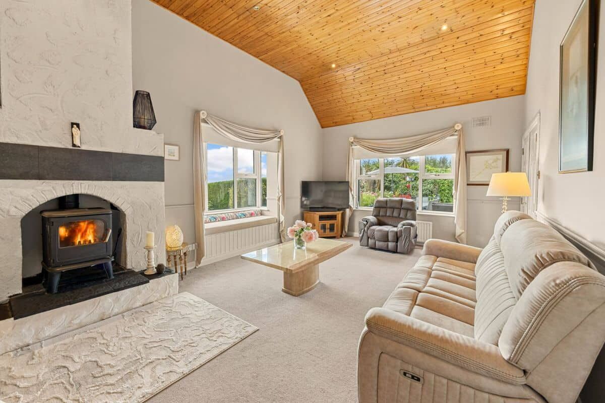 Springhill Lodge Living Room Cozy living room with a fireplace and large windows in Ballycorrigan, Ballina, Co Tipperary.