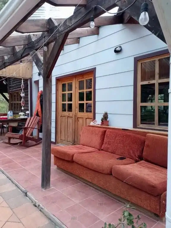 Charming outdoor patio with cozy sofa and rustic decor at Hush Valley Estate, Rio Blanco, San Jose,.