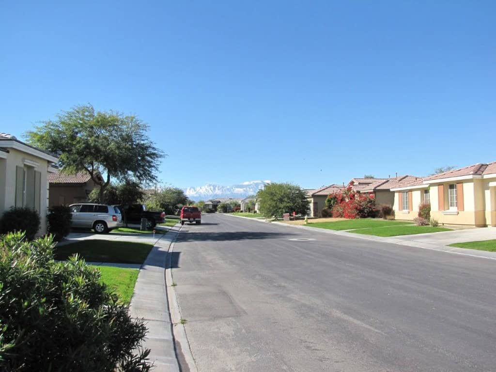 Luxury 4 Bed Villa in Indio California Beautiful residential street in Indio with spacious homes and lush greenery.