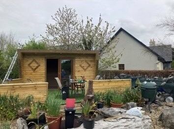 Spacious garden with a wooden shed and outdoor seating area in Tooreen Kilcolgan Galway.