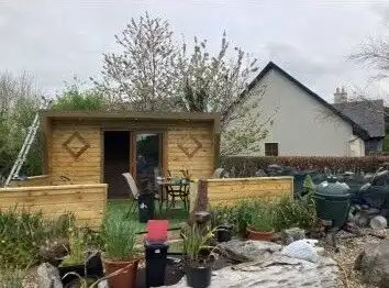 Spacious garden with a wooden shed and outdoor seating area in Tooreen Kilcolgan Galway.