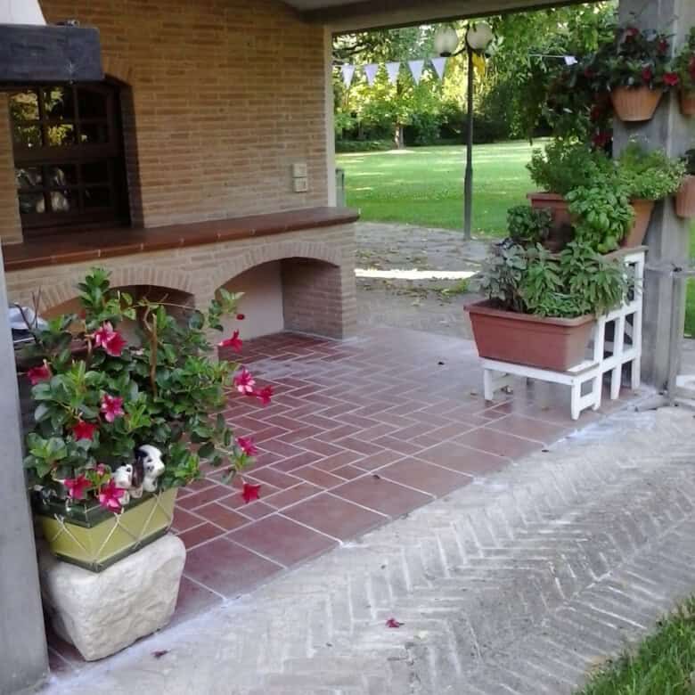 Elegant outdoor patio with potted plants and garden view.