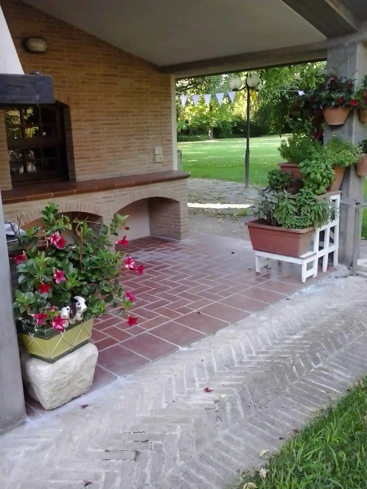 Elegant outdoor patio with potted plants and garden view.