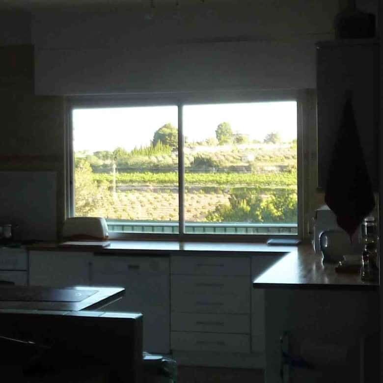 Modern villa interior with large windows overlooking scenic landscape in Valencia.