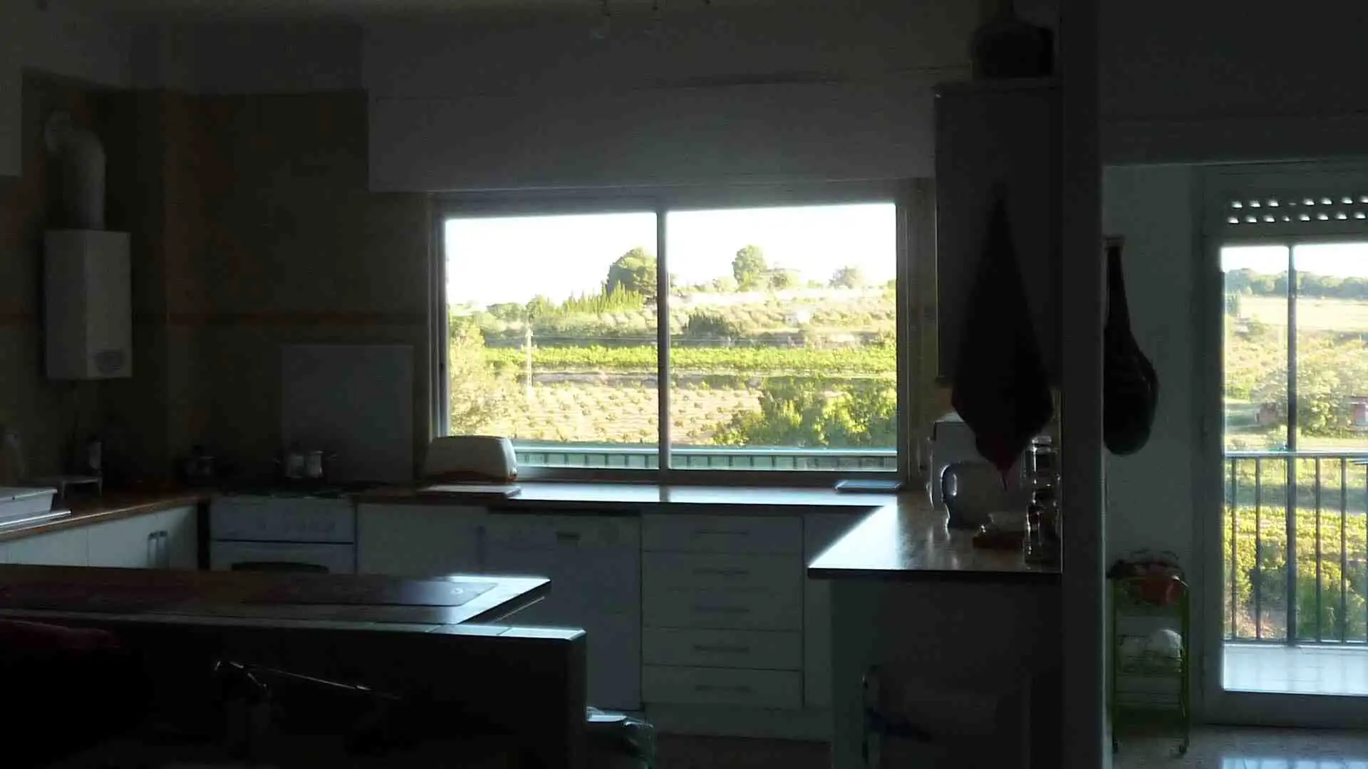 Modern villa interior with large windows overlooking scenic landscape in Valencia.