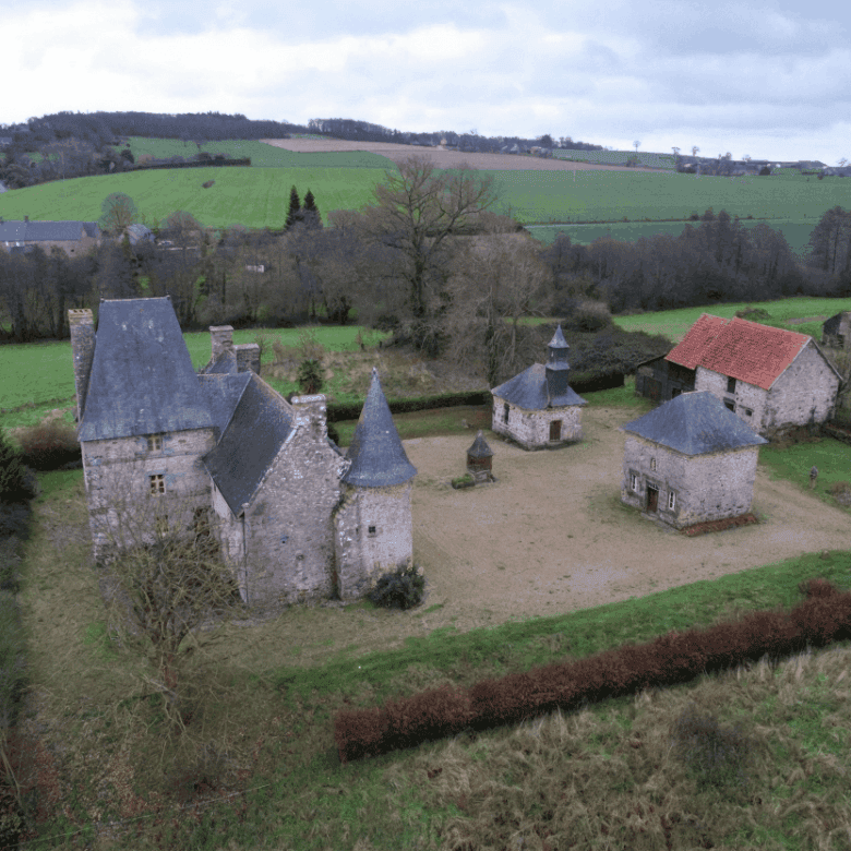Style property with multiple towers and stone walls in Normandy.