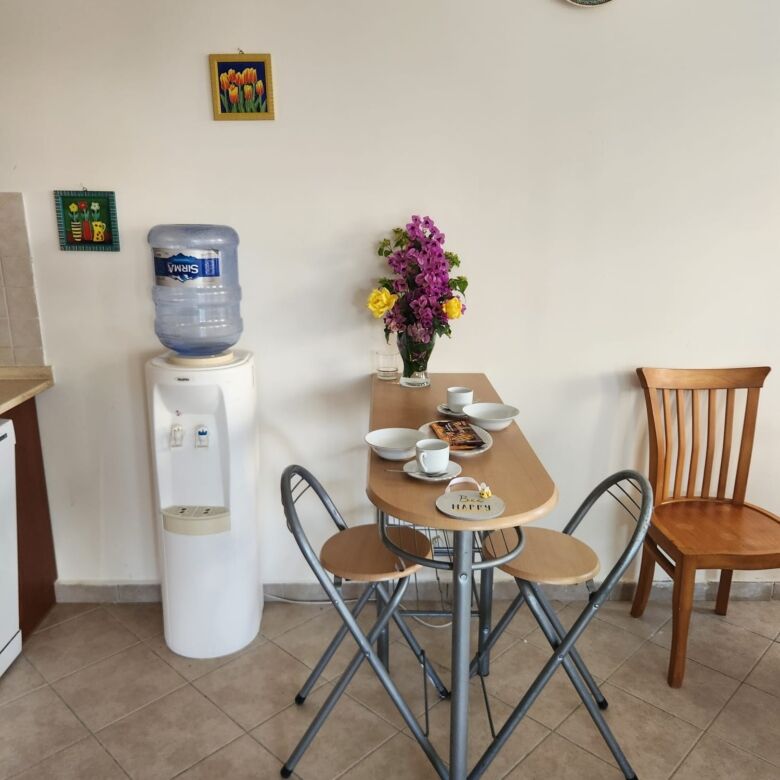 Charming indoor dining space with a small table, four chairs, and decorative wall art in a luxury vi.