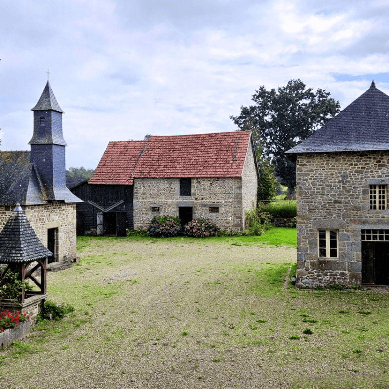 Charming stone manor house with lush gardens in Normandy for sale.