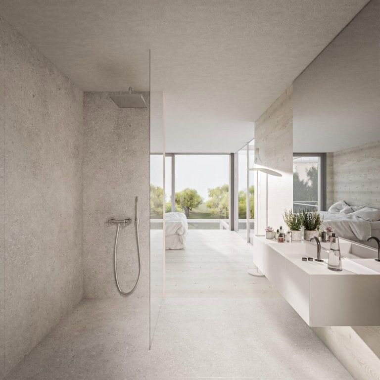 Modern bathroom in luxury villa, open-plan design with large windows and scenic views.