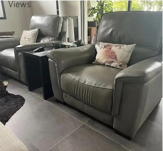 Elegant living room with leather armchairs and decorative pillows in a modern home.