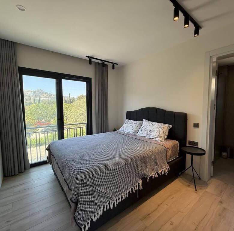 Elegant 2-bedroom apartment with sea views in Yalıkavak Bodrum. Modern interior, balcony, and close.