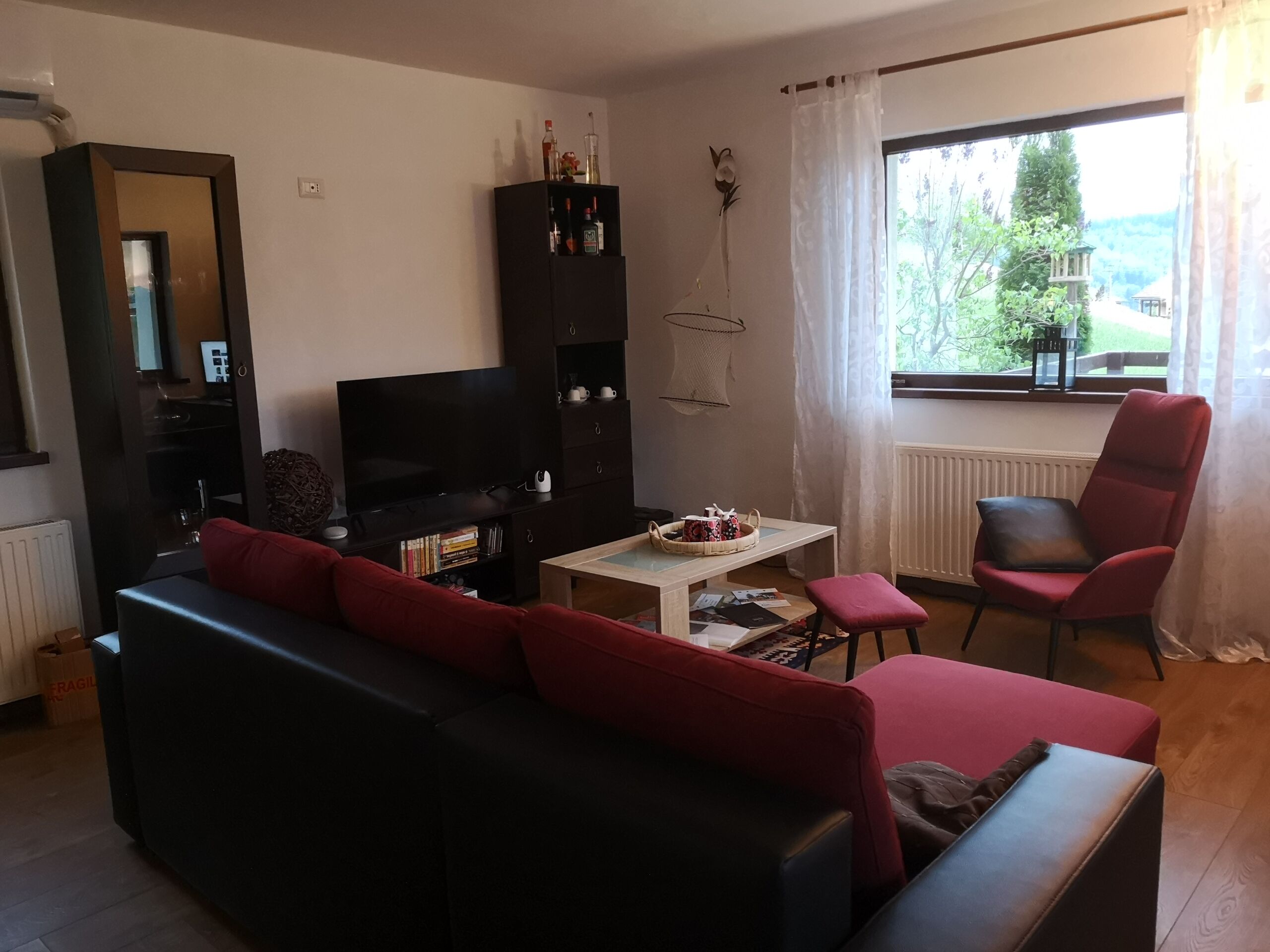Bright living room with comfortable seating and large window views.