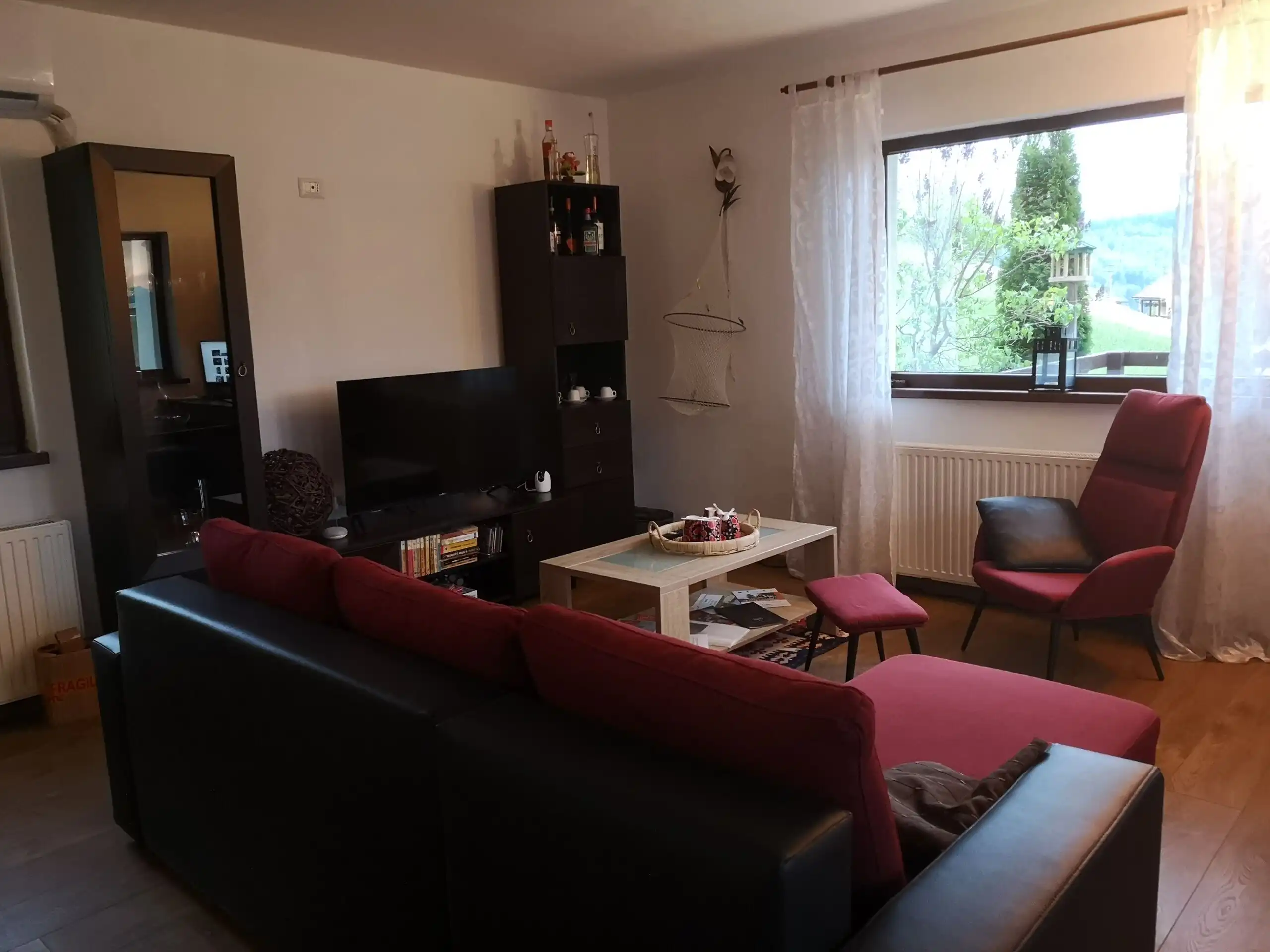 Bright living room with comfortable seating and large window views.