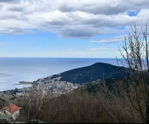 Beautiful land for sale in Budva with stunning views of the Adriatic Sea and surrounding landscape.