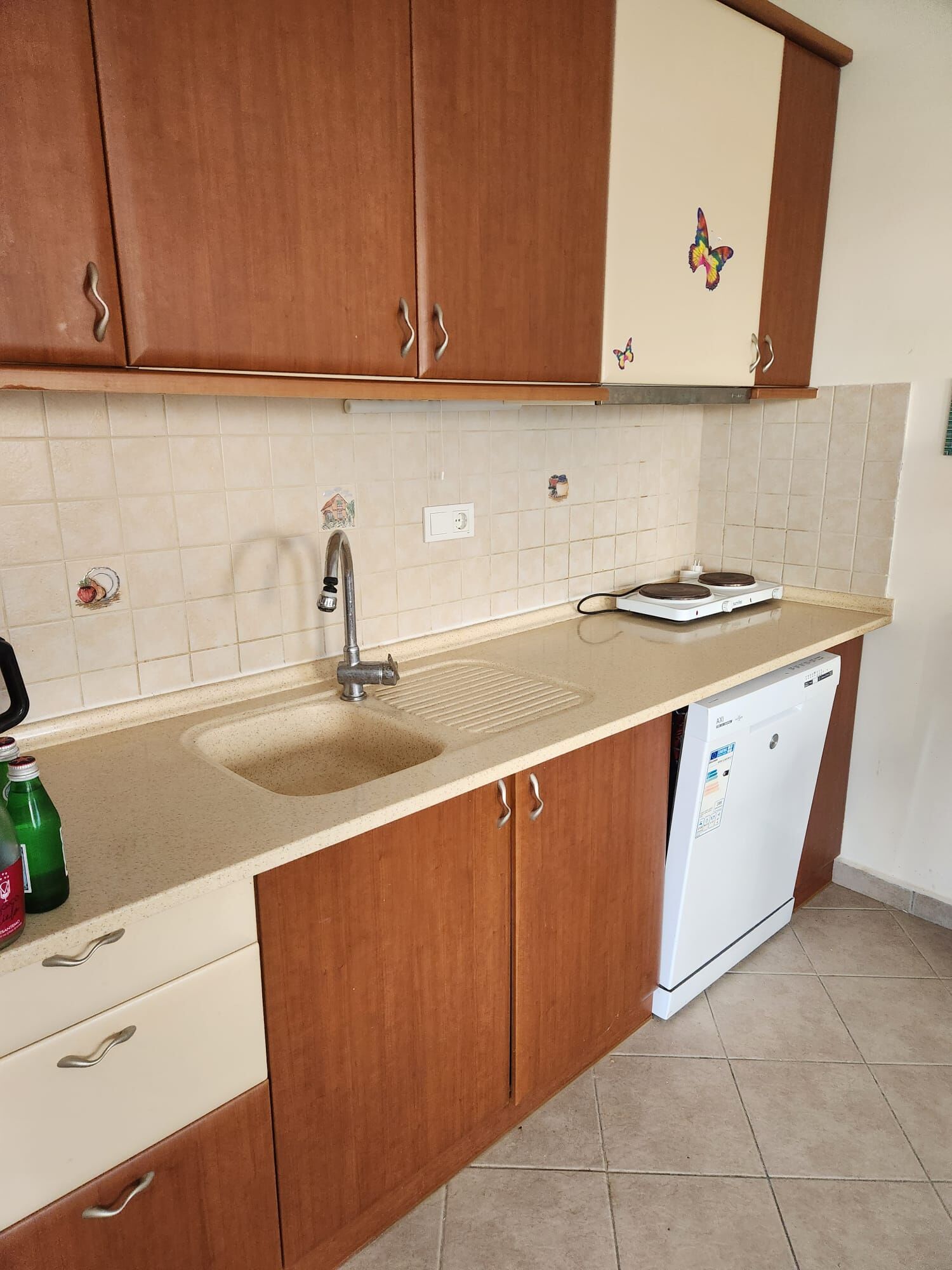 Luxury 3 Bed Villa for Sale in Grand Sea View 1 Gumusluk Spacious kitchen with wooden cabinets, sink, and appliances in a luxury villa in Gumusluk.