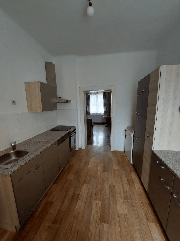 Building with 4 Apartments For Sale in Wilhelmsburg Apartment kitchen in Wilhelmsburg property listing.
