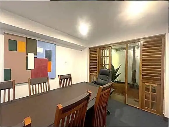 Modern dining room with wooden furniture and artwork.