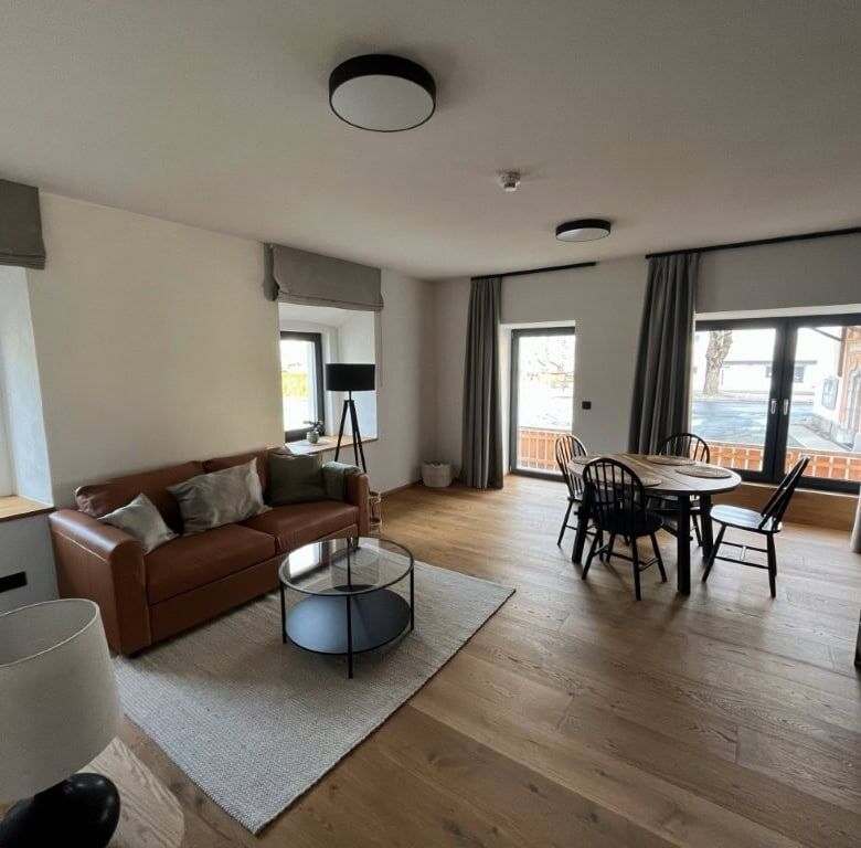 Spacious apartment interior with comfortable seating, dining area, and natural light.