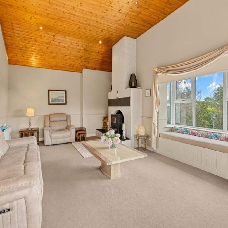 Bright living room with a cozy fireplace and large window views.
