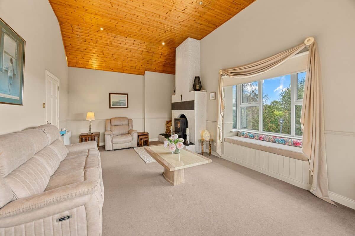 Springhill Lodge Living Room Bright living room with a cozy fireplace and large window views.