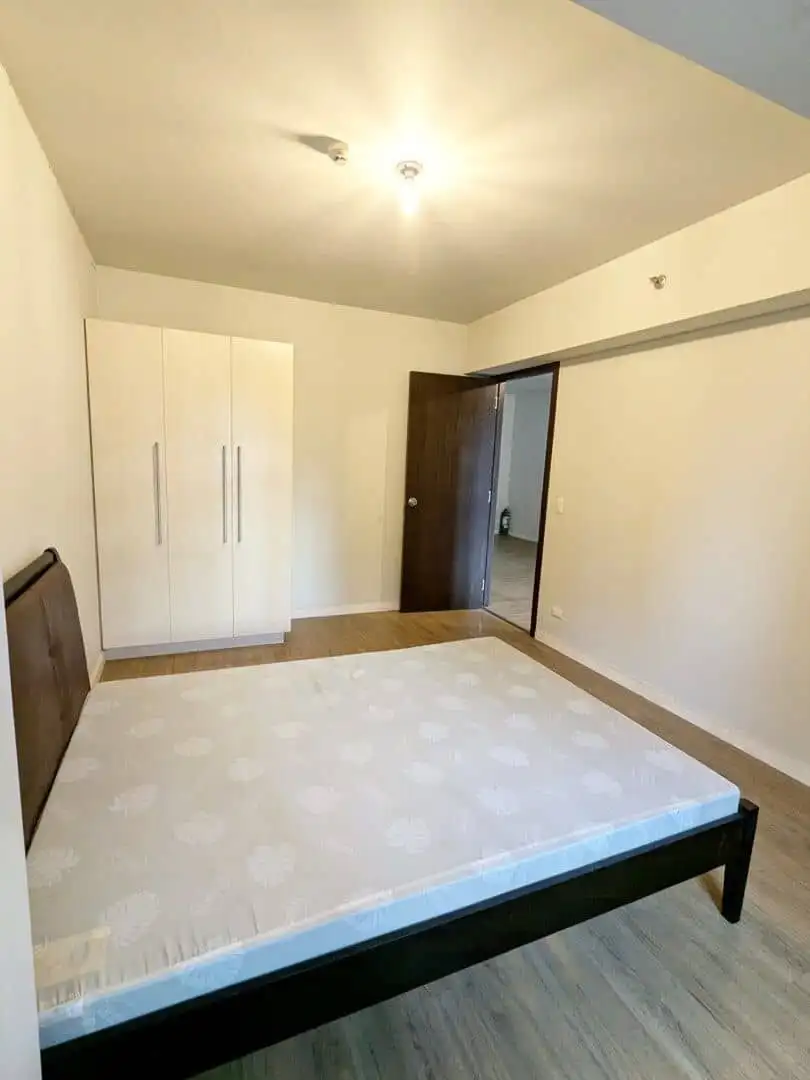 Spacious bedroom with minimalist design in Kroma Tower Manila, ideal for comfortable city living.