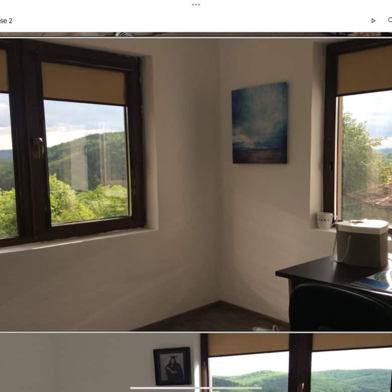 Bright room with large windows showcasing lush mountain scenery. Perfect for relaxing and enjoying n.