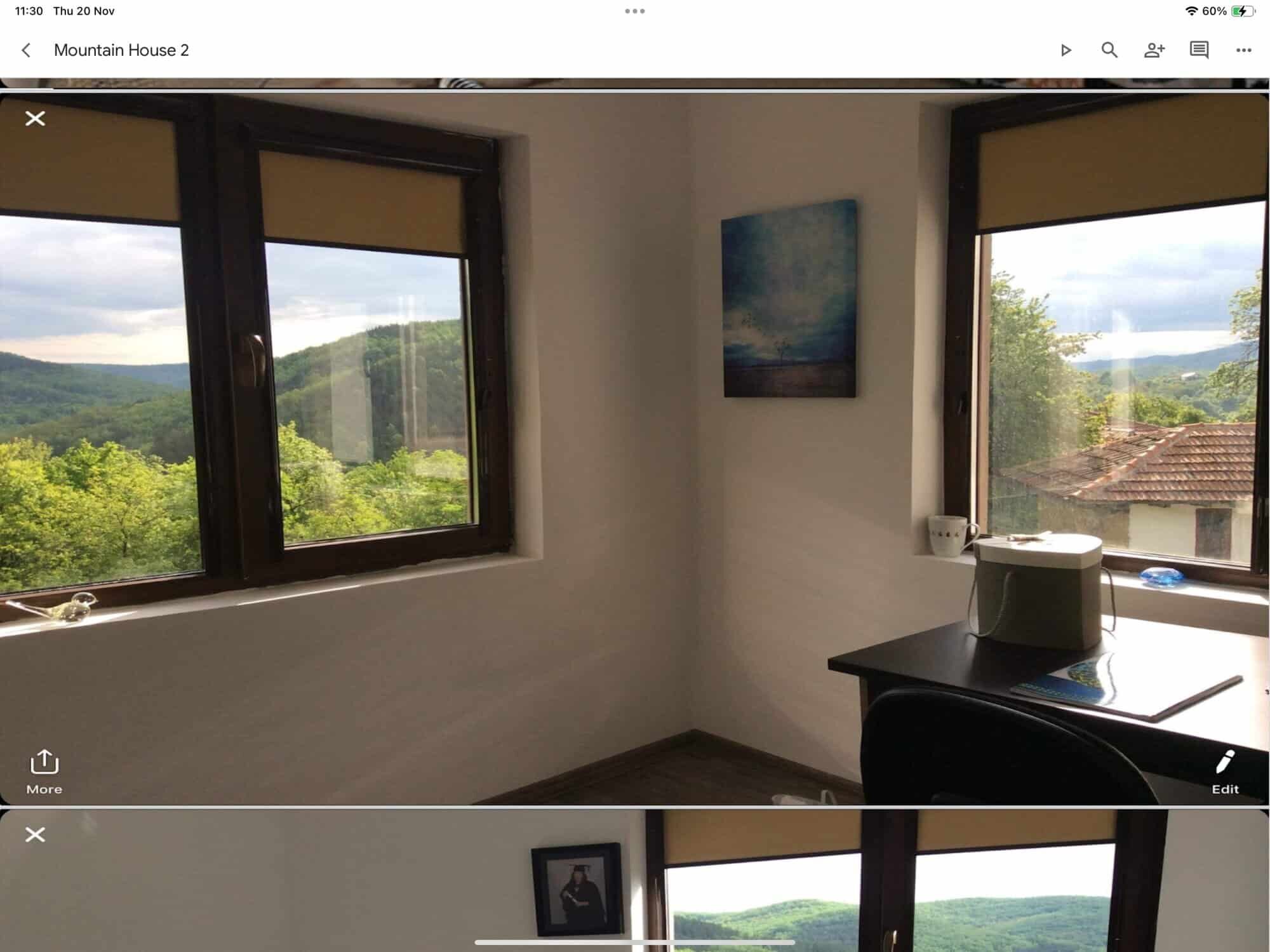 Bright room with large windows showcasing lush mountain scenery. Perfect for relaxing and enjoying n.