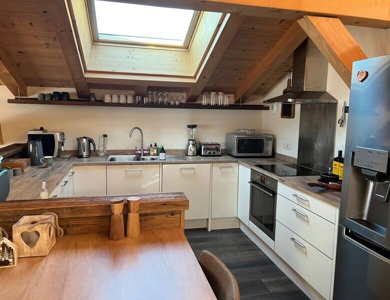 Charming kitchen in a luxury 5-bedroom chalet in Samoens with modern appliances and wooden accents.