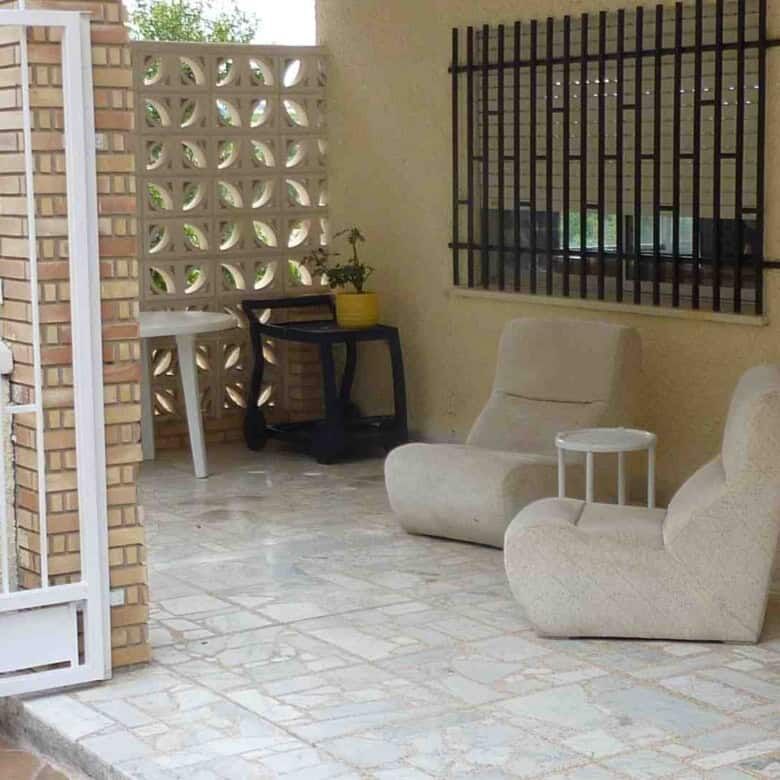 Outdoor seating area with modern chairs in a Valencia villa.