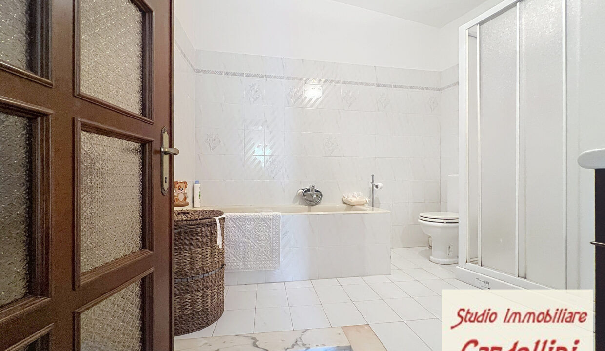 Modern bathroom in a Tuscan house for sale in Fivizzano. Bathroom with bathtub, shower, and toilet in a spacious, bright room.