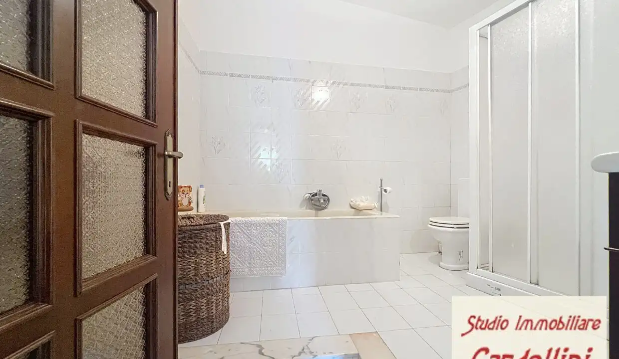 Bathroom with bathtub, shower, and toilet in a spacious, bright room.