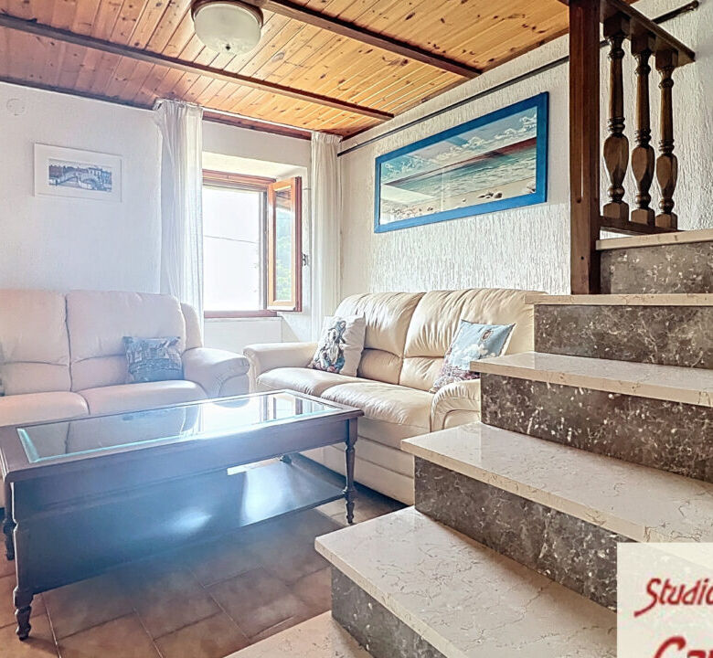 Bright living room with comfortable sofas and wooden ceiling, perfect for relaxing in a charming Tus.