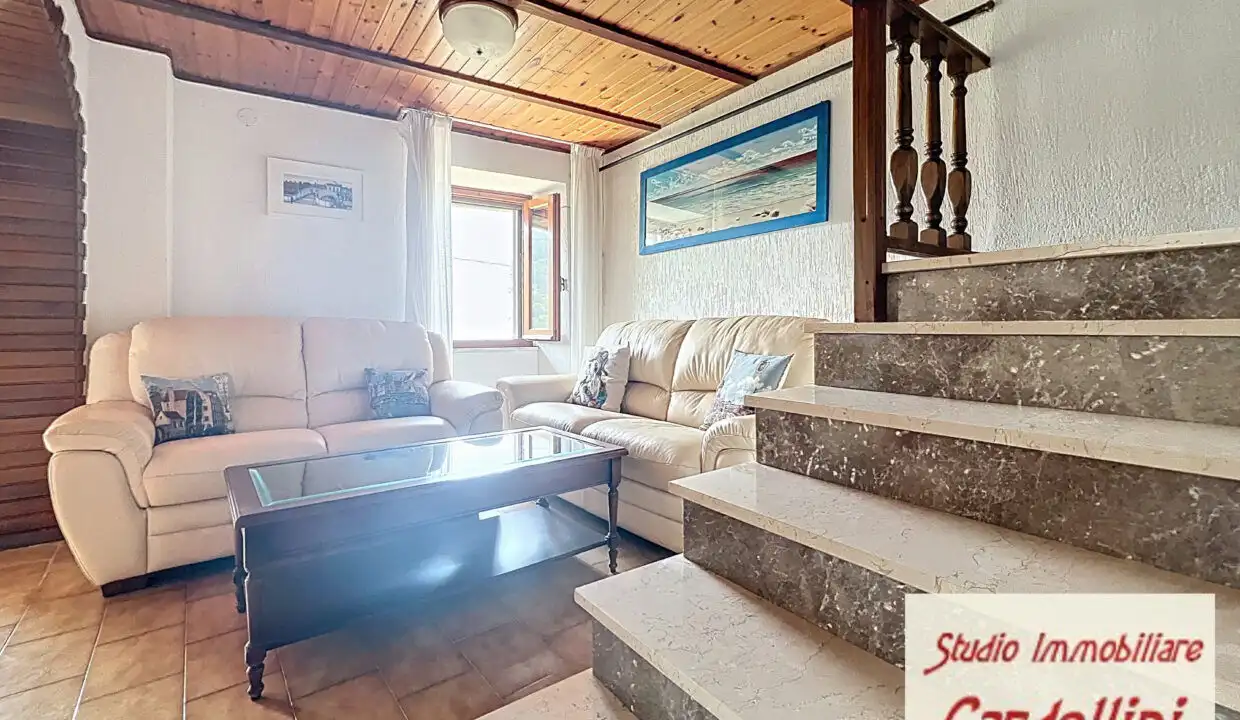 Bright living room with comfortable sofas and wooden ceiling, perfect for relaxing in a charming Tus.