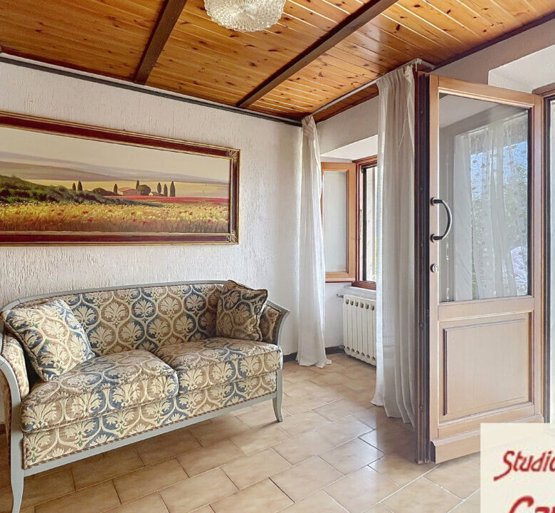 Bright living room with large windows and scenic views in Fivizzano Tuscany. Perfect for relaxing in.