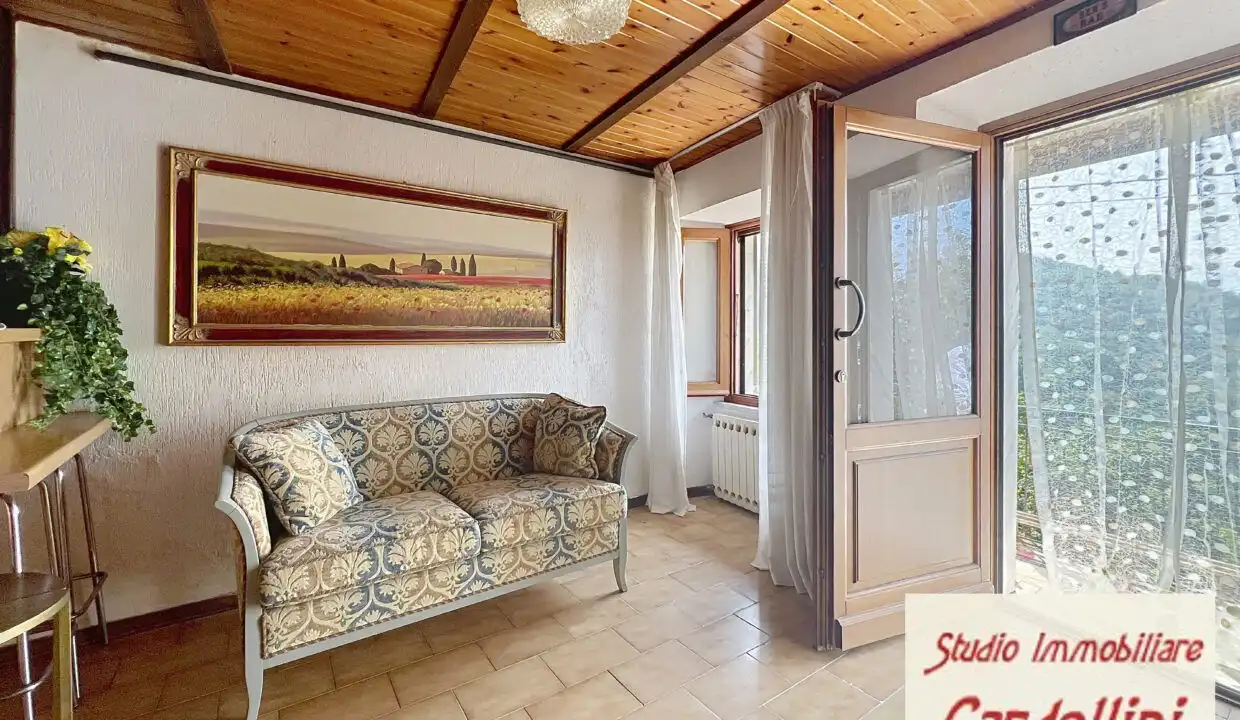 Bright living room with large windows and scenic views in Fivizzano Tuscany. Perfect for relaxing in.