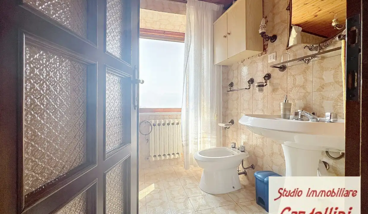 Bright bathroom with vintage decor in Fivizzano Tuscany, featuring a classic sink, toilet, and natur.