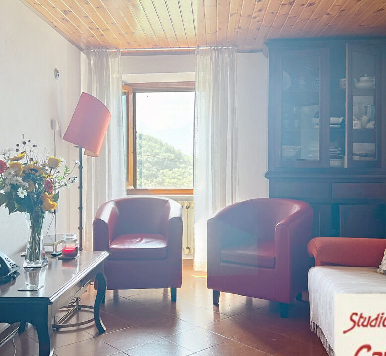 Charming 4-bedroom house for sale in Fivizzano, Tuscany, featuring a cozy living room with natural l.