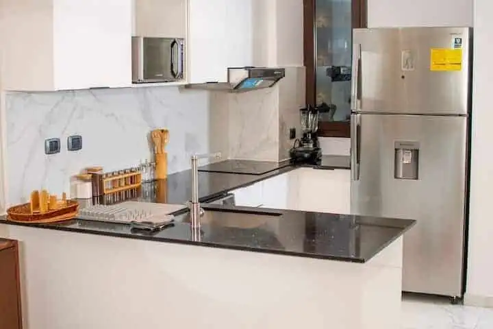 Modern kitchen with stainless steel appliances in Cana Rock STAR, Punta Cana.
