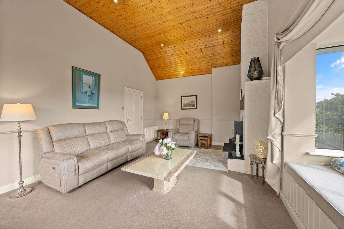Springhill Lodge Living Room Bright living room with comfortable sofas and a cozy fireplace in Ballycorrigan, Ballina.