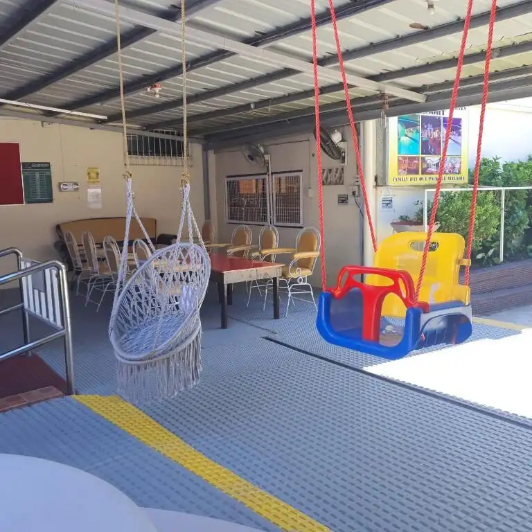 Playground with swings and hanging chair at Martin Family Resort Hotel, Cavite. Perfect for family f.