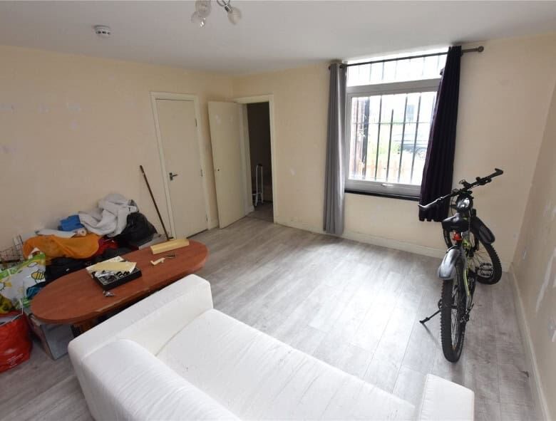 Interior view of a flat in Leeds with a bicycle and minimal furnishings.