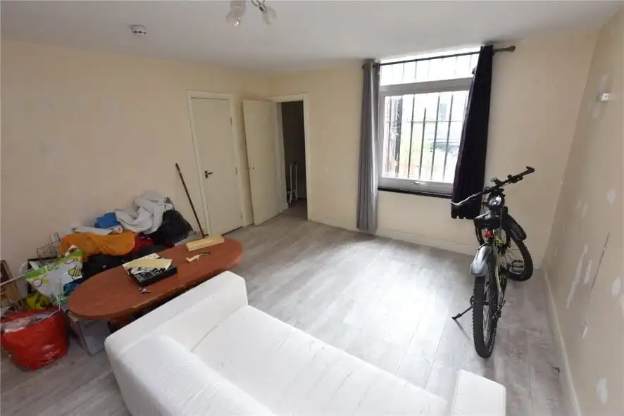 Interior view of a flat in Leeds with a bicycle and minimal furnishings.