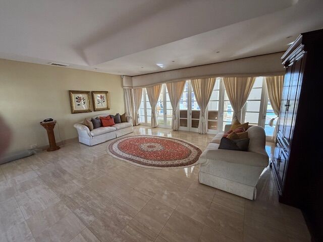 Spacious living room of a luxury 5-bedroom villa in Morning Side, Durban, featuring large windows an.