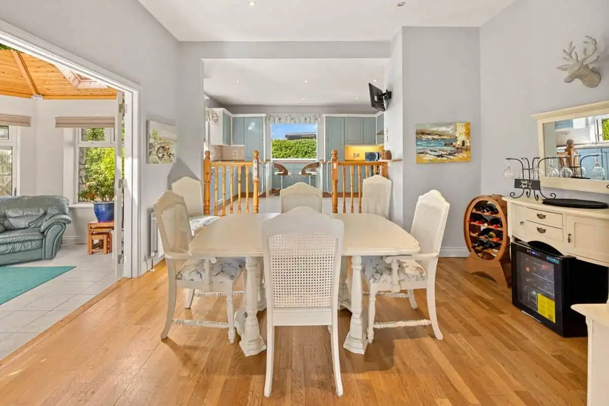 Spacious living room with large windows offering stunning views in this Bella Coola estate. Perfect.