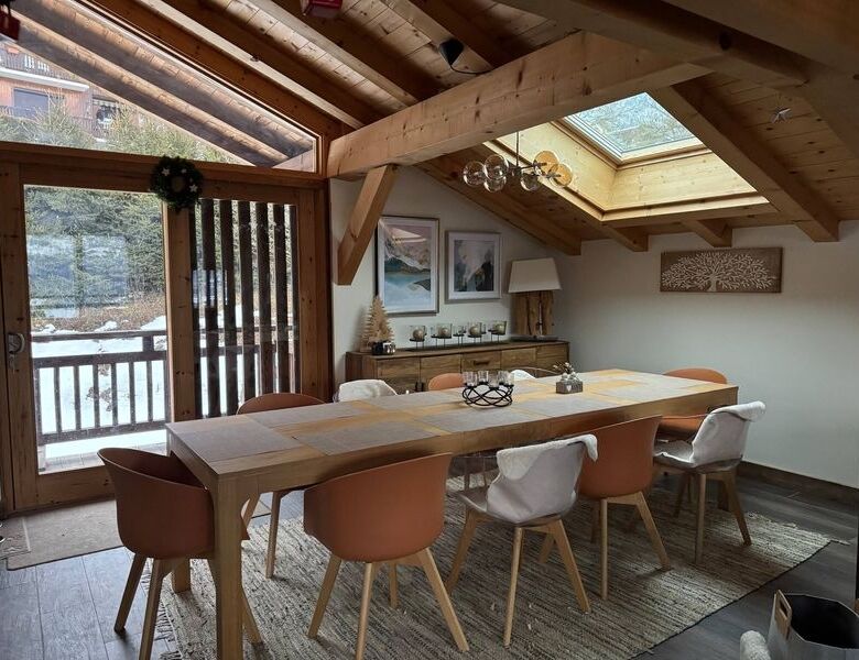 Luxury 5 Bed Chalet Dining Area with wooden beams and skylights.