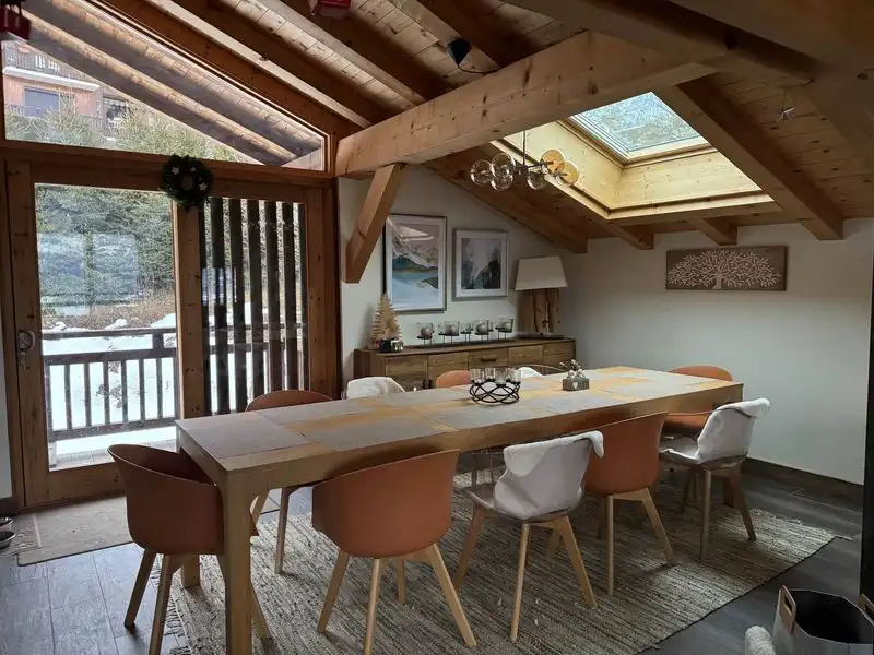 Luxury 5 Bed Chalet Dining Area with wooden beams and skylights.