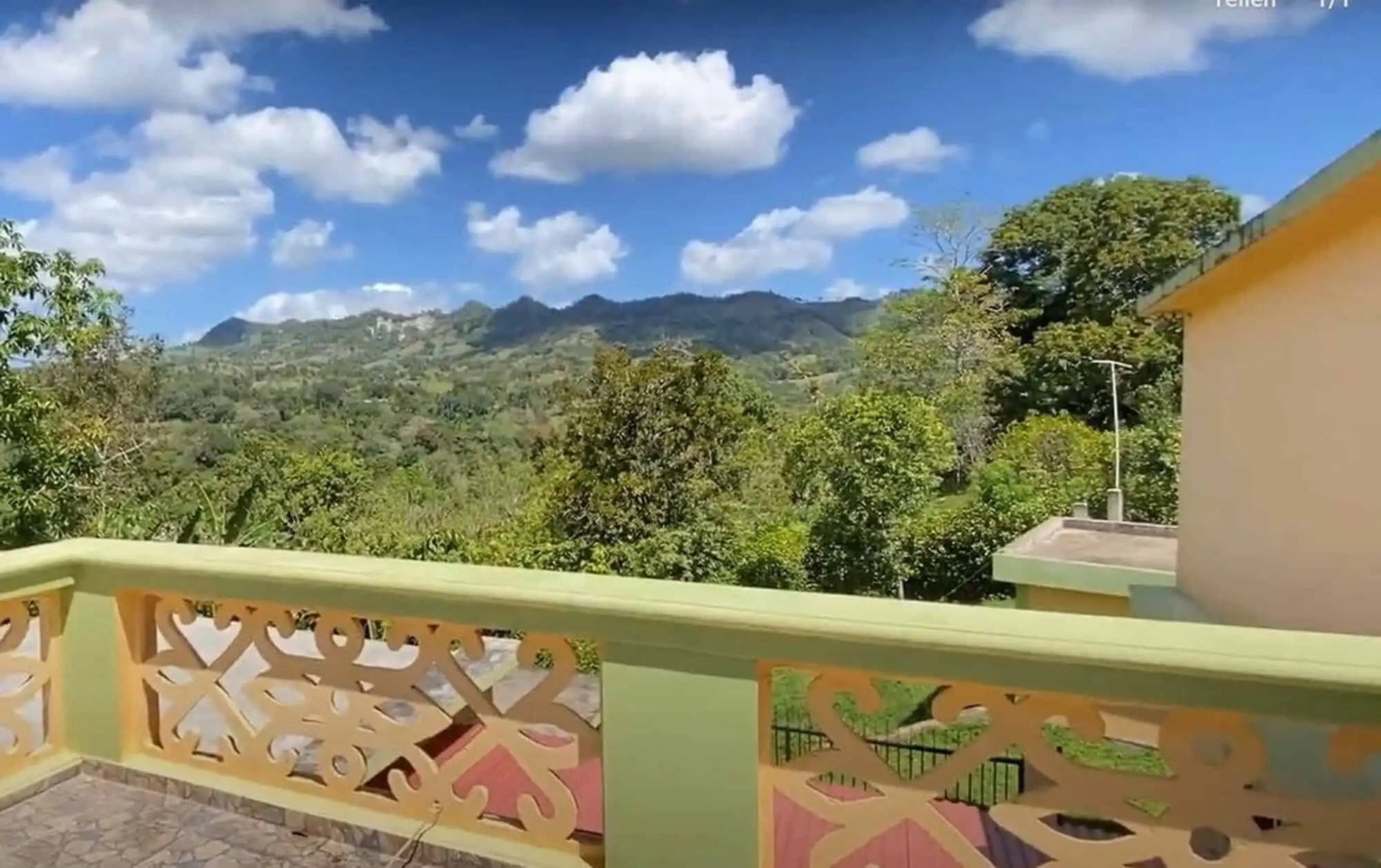 Scenic view from a balcony overlooking lush greenery and mountains in the Dominican Republic.