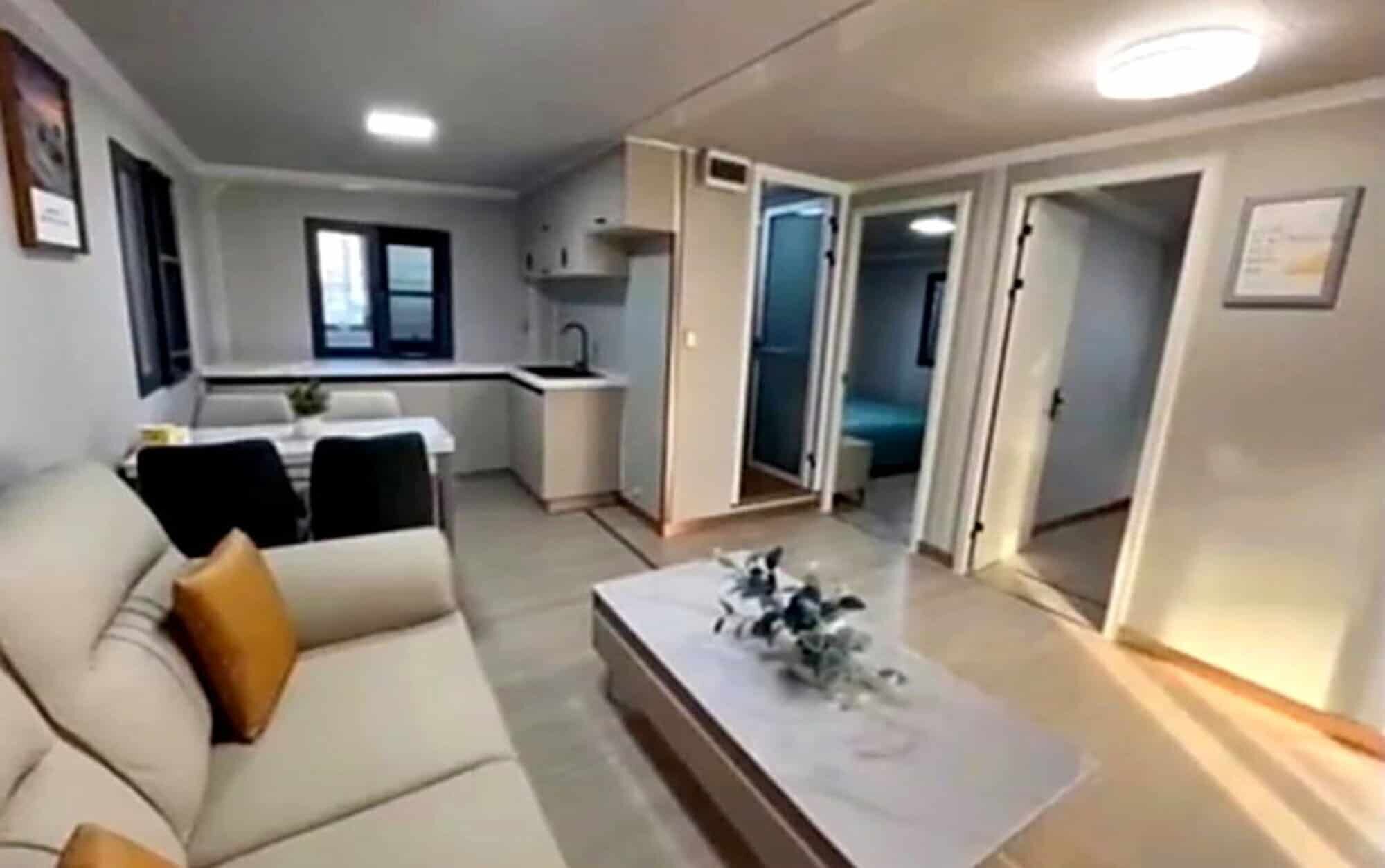 Modern holiday apartment interior in Martinique resort. Cozy living space with open-plan kitchen and comfortable seating area.